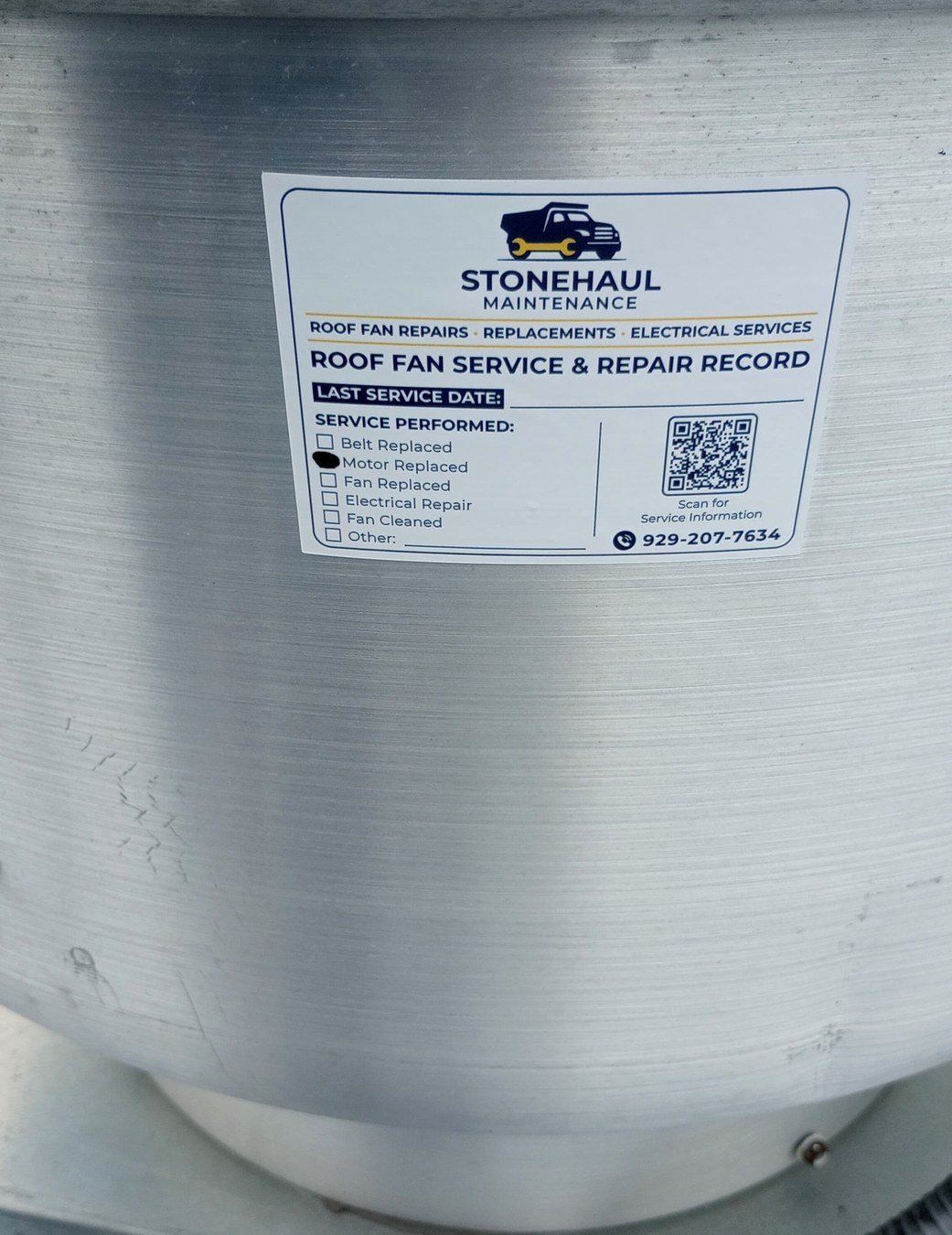 Service record sticker on a roof fan housing